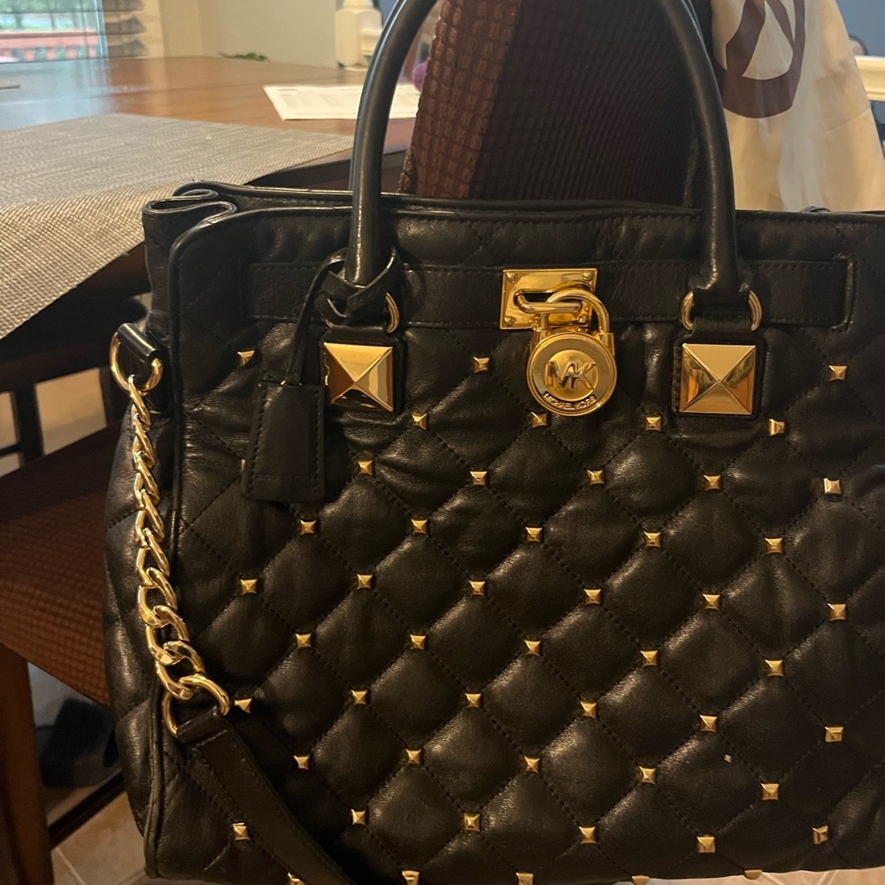 Michael Kors leather studded hand bag with strap.
